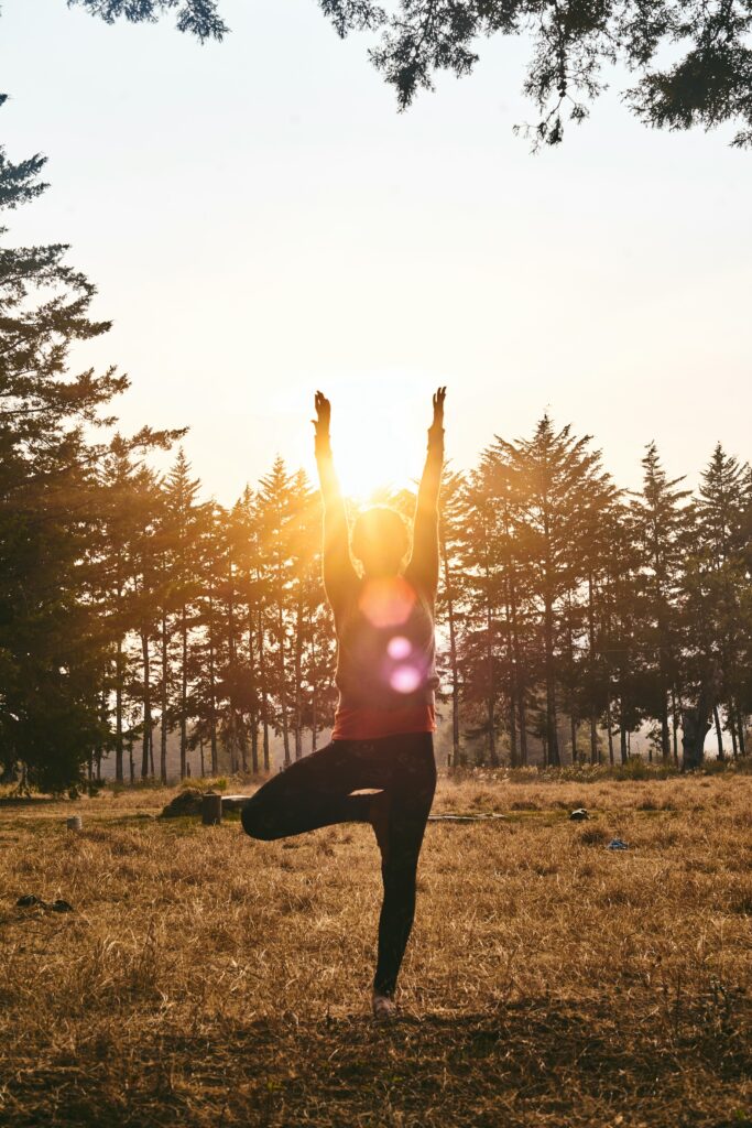 Silouhette of a woman doing yoga in the sun